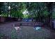 Large backyard with mature trees, fire pit and corn hole game at 112 S Spencer Ave, Indianapolis, IN 46219