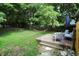 Relaxing backyard setup featuring a hammock, patio seating, and blooming flowers, perfect for unwinding at 112 S Spencer Ave, Indianapolis, IN 46219
