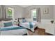 Bright bedroom featuring twin beds, stylish decor, and a serene ambiance perfect for restful nights at 112 S Spencer Ave, Indianapolis, IN 46219