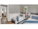 Cozy bedroom with twin beds, neutral decor, and ample natural light, creating a welcoming atmosphere at 112 S Spencer Ave, Indianapolis, IN 46219