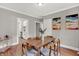 Spacious dining room featuring hardwood floors, modern décor, and ample seating at 112 S Spencer Ave, Indianapolis, IN 46219