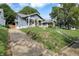 Inviting home with a well-manicured lawn and charming curb appeal, set on a tranquil street at 112 S Spencer Ave, Indianapolis, IN 46219