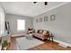 Inviting living room with hardwood floors, area rug, and ample natural light at 112 S Spencer Ave, Indianapolis, IN 46219