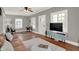 Bright living room with hardwood floors, ceiling fan, and modern décor at 112 S Spencer Ave, Indianapolis, IN 46219