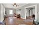 Open-concept living room with hardwood floors and view into dining area at 112 S Spencer Ave, Indianapolis, IN 46219