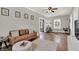 Spacious living room featuring hardwood floors, neutral paint, stylish furniture, and natural light at 112 S Spencer Ave, Indianapolis, IN 46219
