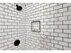 Updated shower features black fixtures, subway tile and shower niche at 112 S Spencer Ave, Indianapolis, IN 46219