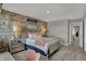 Comfortable bedroom showcases a brick accent wall, soft lighting, and a cozy atmosphere at 11599 Aubrey Ln, Fishers, IN 46040