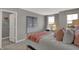 Well-lit bedroom features a desk area, cozy bed, and closet access, perfect for relaxation at 11599 Aubrey Ln, Fishers, IN 46040