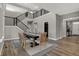 Elegant dining room featuring hardwood floors and a modern staircase with black metal railing at 11599 Aubrey Ln, Fishers, IN 46040