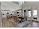 Bright, open-concept dining room with a modern table, chairs, and access to kitchen at 11599 Aubrey Ln, Fishers, IN 46040