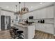 Stylish kitchen with quartz countertops, stainless steel appliances, and seating at the island at 11599 Aubrey Ln, Fishers, IN 46040