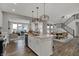 Modern kitchen with island seating and stainless appliances open to the dining and living spaces at 11599 Aubrey Ln, Fishers, IN 46040