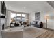Bright living area with a fireplace, large windows, and contemporary furnishings at 11599 Aubrey Ln, Fishers, IN 46040