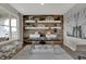 Stylish home office featuring a wood accent wall, built-in shelves, and a comfortable workspace at 11599 Aubrey Ln, Fishers, IN 46040