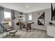 Comfortable office space featuring a wooden desk, gray accent chair, and soft, natural lighting for a productive atmosphere at 11599 Aubrey Ln, Fishers, IN 46040