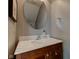 Stylish bathroom featuring a wood vanity with marble countertop and an oval mirror at 12683 White Chapel Cir, Fishers, IN 46037