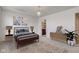 Staged bedroom with a stylish bed, soft rug, and an ensuite bath view at 12683 White Chapel Cir, Fishers, IN 46037
