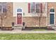Attractive front entrances of townhomes with colorful doors, brick exteriors, and manicured landscaping at 12683 White Chapel Cir, Fishers, IN 46037