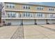 View of the back of the townhouse with garage parking under each unit at 12683 White Chapel Cir, Fishers, IN 46037