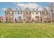 Townhomes with brick and siding, colorful doors, and manicured lawns in a quiet community at 12683 White Chapel Cir, Fishers, IN 46037