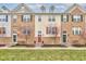 Townhomes with brick and siding, green doors, and manicured lawns in a well-maintained community at 12683 White Chapel Cir, Fishers, IN 46037