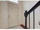 Bright foyer with white door, dark trim, wood floors, and decorative rug by the stairs at 12683 White Chapel Cir, Fishers, IN 46037