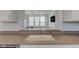 Open concept kitchen features a sink overlooking the living room and stainless steel faucet at 12683 White Chapel Cir, Fishers, IN 46037