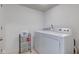 Cozy laundry room includes a washer, dryer, and storage rack on wheels for cleaning supplies at 12683 White Chapel Cir, Fishers, IN 46037