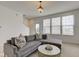 Cozy living room with a gray sectional sofa and bright natural light at 12683 White Chapel Cir, Fishers, IN 46037