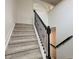 Carpeted staircase with dark trim and handrail leading to the upper level of the home at 12683 White Chapel Cir, Fishers, IN 46037