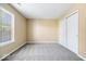 Neutral bedroom features plush carpet, fresh paint, and a large window that brings in natural light at 12741 Glengary Dr, Fishers, IN 46038