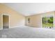 Spacious living area featuring plush carpeting, sliding glass doors, and abundant natural light at 12741 Glengary Dr, Fishers, IN 46038