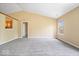 Bright and airy living space featuring new carpets, a view to the kitchen, and a large window at 12741 Glengary Dr, Fishers, IN 46038