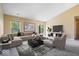 Bright living room boasts a large sectional, modern decor, and sliding glass doors to the backyard at 12741 Glengary Dr, Fishers, IN 46038