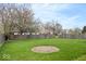 Large backyard featuring a well-maintained lawn with a partially fenced yard and mature trees at 12949 Shandon Ln, Fishers, IN 46038