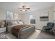 Cozy bedroom featuring a queen bed, ceiling fan, and bright window with a view of the outdoors at 12949 Shandon Ln, Fishers, IN 46038
