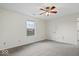 Bright bedroom featuring a ceiling fan, carpeted floors, and a window bringing in natural light at 12949 Shandon Ln, Fishers, IN 46038