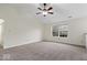 Spacious room with vaulted ceiling, plush carpet, and a bright window overlooking the front yard at 12949 Shandon Ln, Fishers, IN 46038