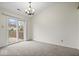 Dining room featuring sliding glass door, modern chandelier, and neutral carpet at 12949 Shandon Ln, Fishers, IN 46038
