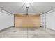 Spacious two-car garage with concrete floors, shelving units, and a beige garage door at 12949 Shandon Ln, Fishers, IN 46038