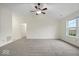 Bright living room with high ceilings, neutral carpet, and a large window at 12949 Shandon Ln, Fishers, IN 46038