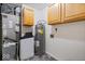 Utility room featuring a water heater, water softener, furnace, and storage cabinets at 12949 Shandon Ln, Fishers, IN 46038