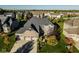 Aerial view of a brick and stone home with an attached three car garage in a desirable neighborhood at 14910 Briarpatch Cir, Carmel, IN 46033