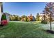 Expansive back yard featuring lush lawn, mature trees, and frost covered grass at 14910 Briarpatch Cir, Carmel, IN 46033
