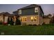 Charming backyard with a brick exterior, covered patio, and lush green lawn, ideal for outdoor entertaining at 14910 Briarpatch Cir, Carmel, IN 46033
