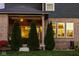 Charming backyard with a brick exterior, covered patio, and lush green lawn, ideal for outdoor enjoyment at 14910 Briarpatch Cir, Carmel, IN 46033