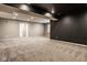 Large basement area with neutral carpet, ample space, and modern lighting for flexible living at 14910 Briarpatch Cir, Carmel, IN 46033