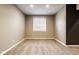 Spacious, carpeted basement with a window, offering natural light and potential for various uses at 14910 Briarpatch Cir, Carmel, IN 46033