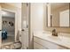 Bathroom featuring a white sink, with a door leading to a bedroom, enhancing the functionality of the space at 14910 Briarpatch Cir, Carmel, IN 46033